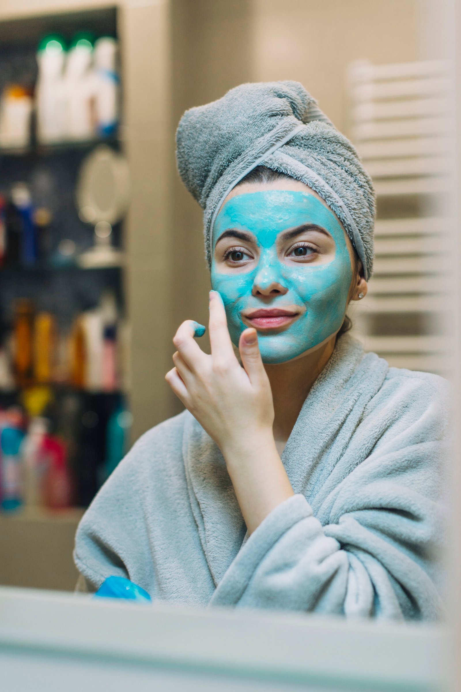 young-woman-applying-blue-mask